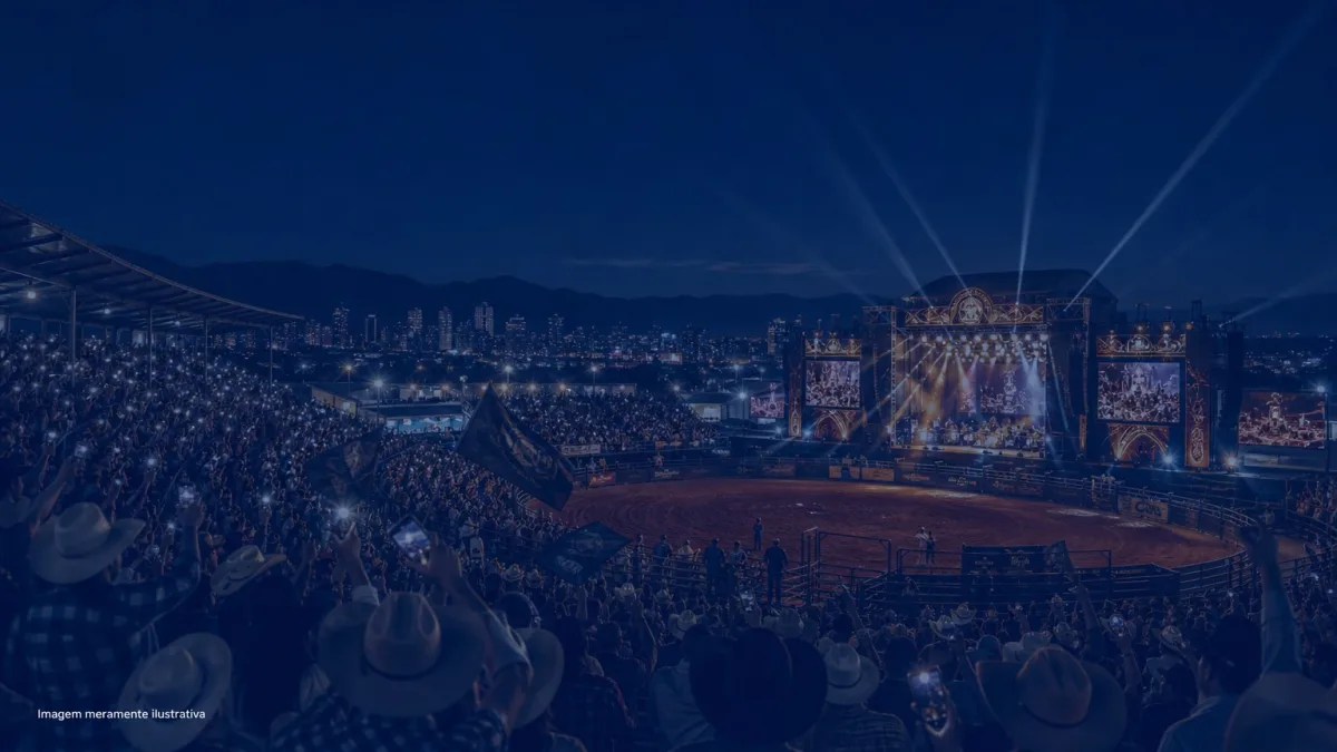 Arena de rodeio à noite com palco iluminado e arquibancada cheia, imagem meramente ilustrativa